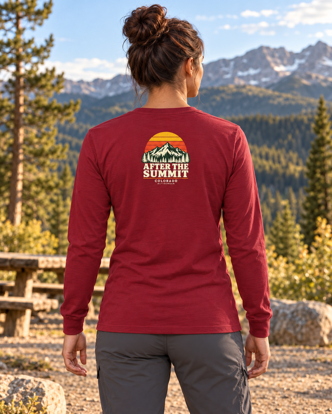 Woman wearing the After the Summit Jersey Long Sleeve in Cardinal outdoors, showing the compact retro mountain back graphic.