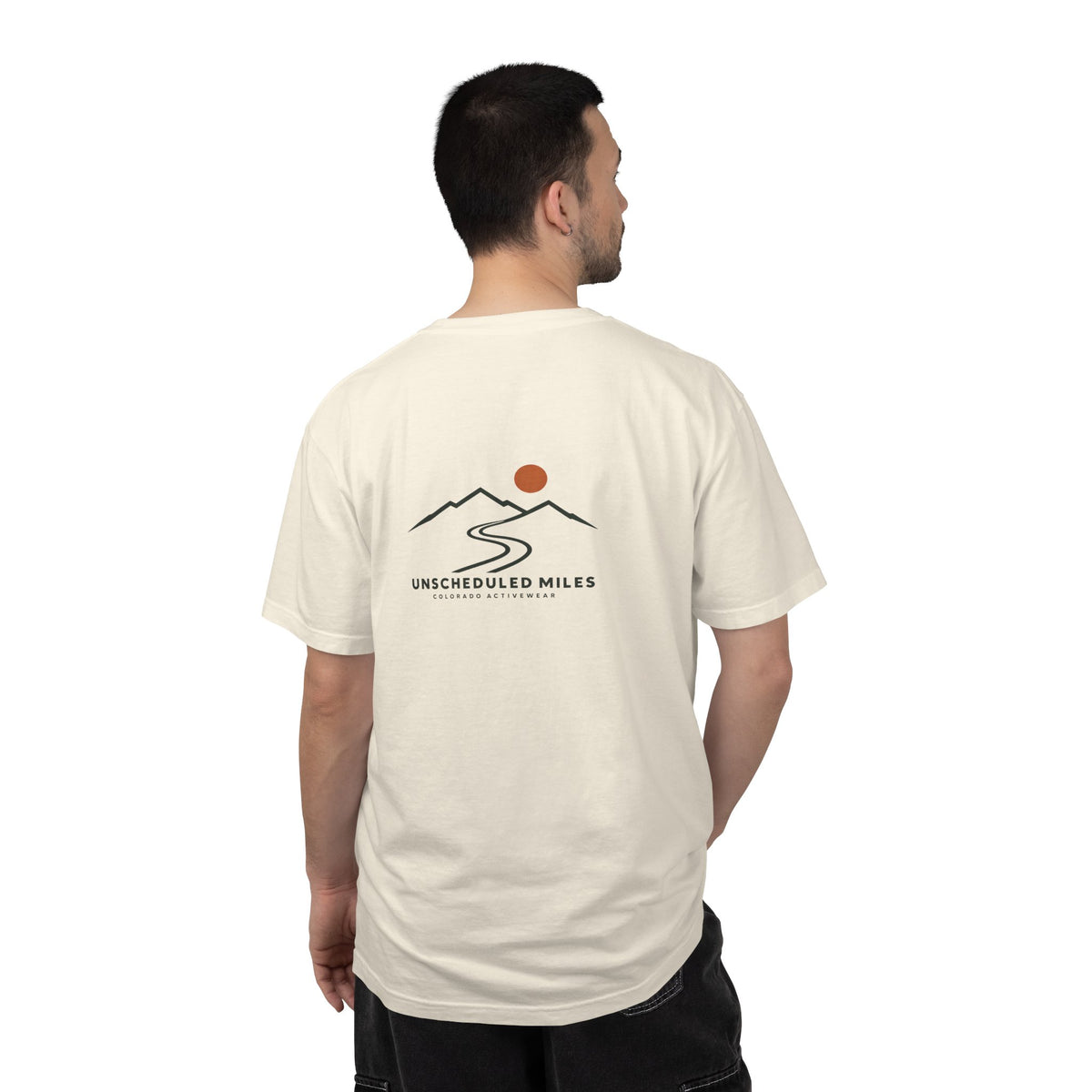 Supplier product mockup showing a man wearing the Ivory Unscheduled Miles Road Tee, back view.