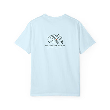 Chambray Mountain Hours Contour Tee, back view with compact contour-line graphic; illustrative product mockup.